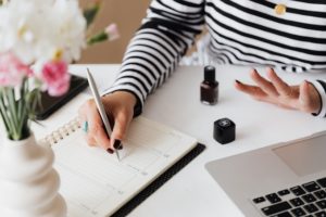 Woman writing on calendar